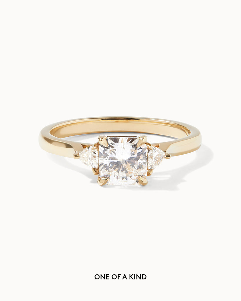 Radiant Cut white diamond with Trillion side stones set on a recycled 9ct solid yellow gold band handcrafted in London by Maya Magal