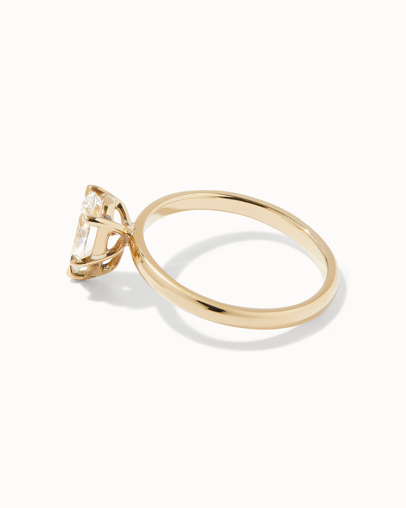 Pear cut lab grown white diamond solitaire ring set in a recycled 9 ct solid yellow gold band handcrafted in London by Maya Magal
