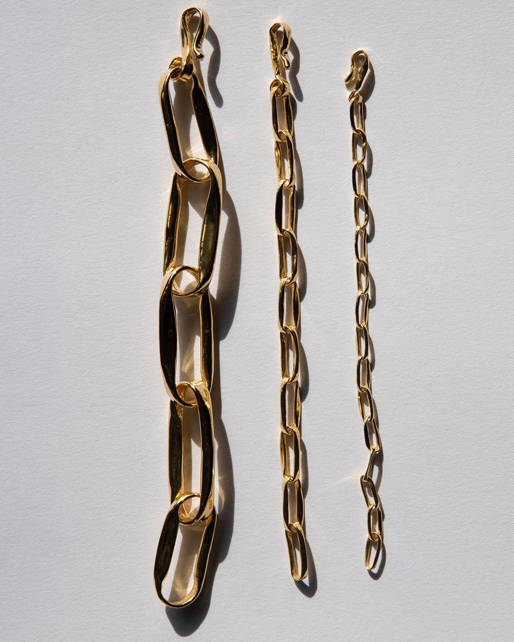 18 Ct gold plated brass MM STUDIO Link Heavy Chain Bracelet displayed on white background with 2 other bracelets