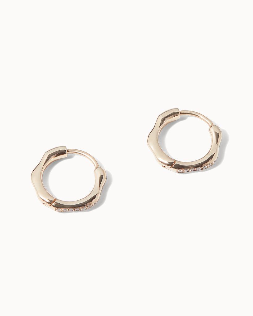 Helios huggie hoop earrings made with solid gold and sparkling diamonds by Maya Magal London