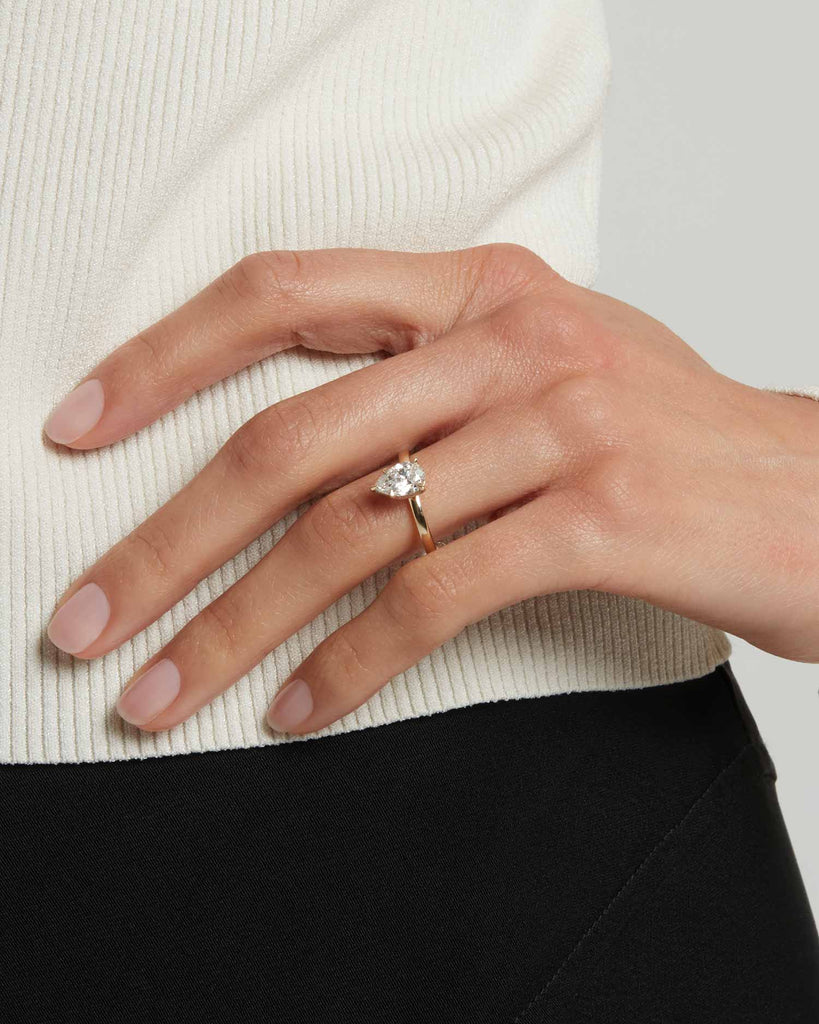 Pear cut lab grown white diamond solitaire ring set in a recycled 9 ct solid yellow gold band handcrafted in London by Maya Magal