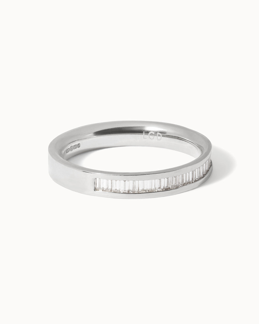 Side view of Platinum Baguette Diamond Channel Ring on white background.