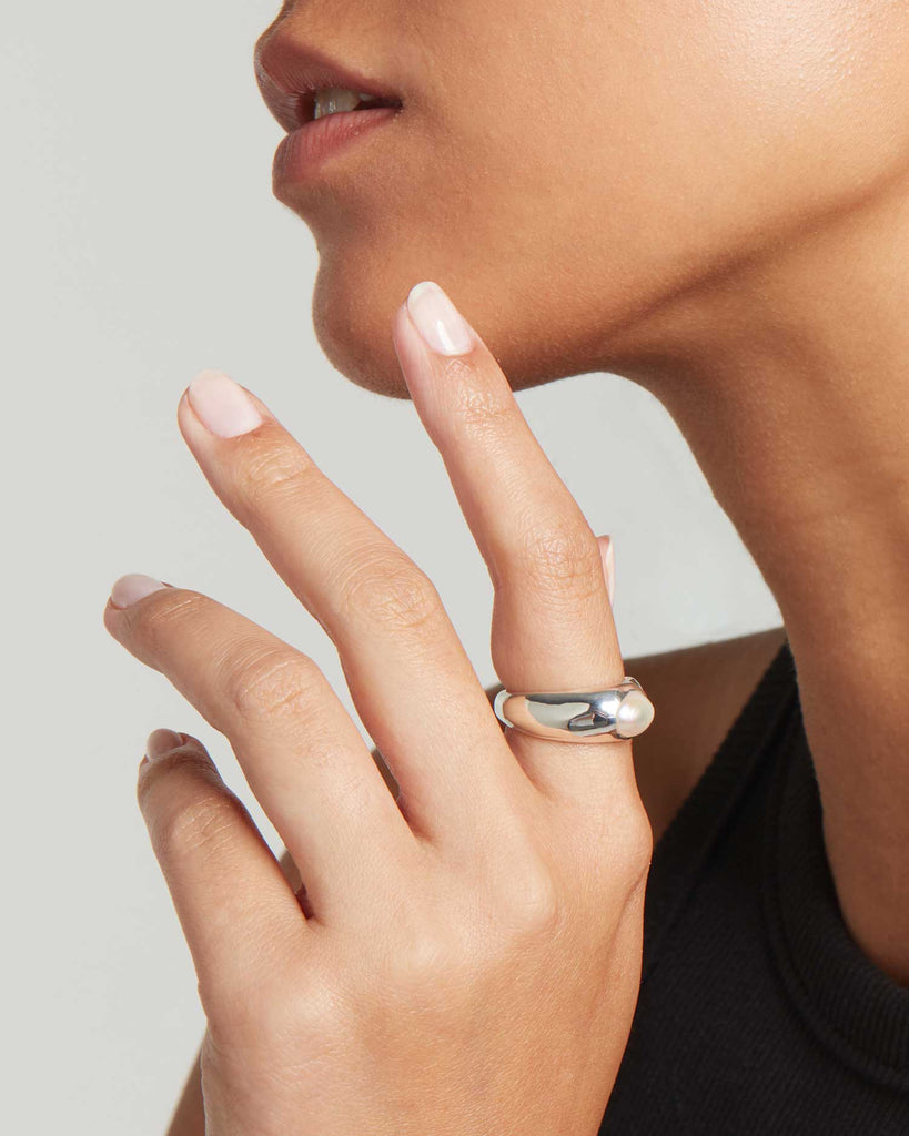 Model wears bold baroque pearl and recycled sterling silver signet ring handcrafted in our London workshops