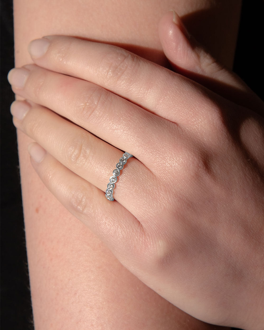 Platinum Bezel Diamond Eternity Ring on finger