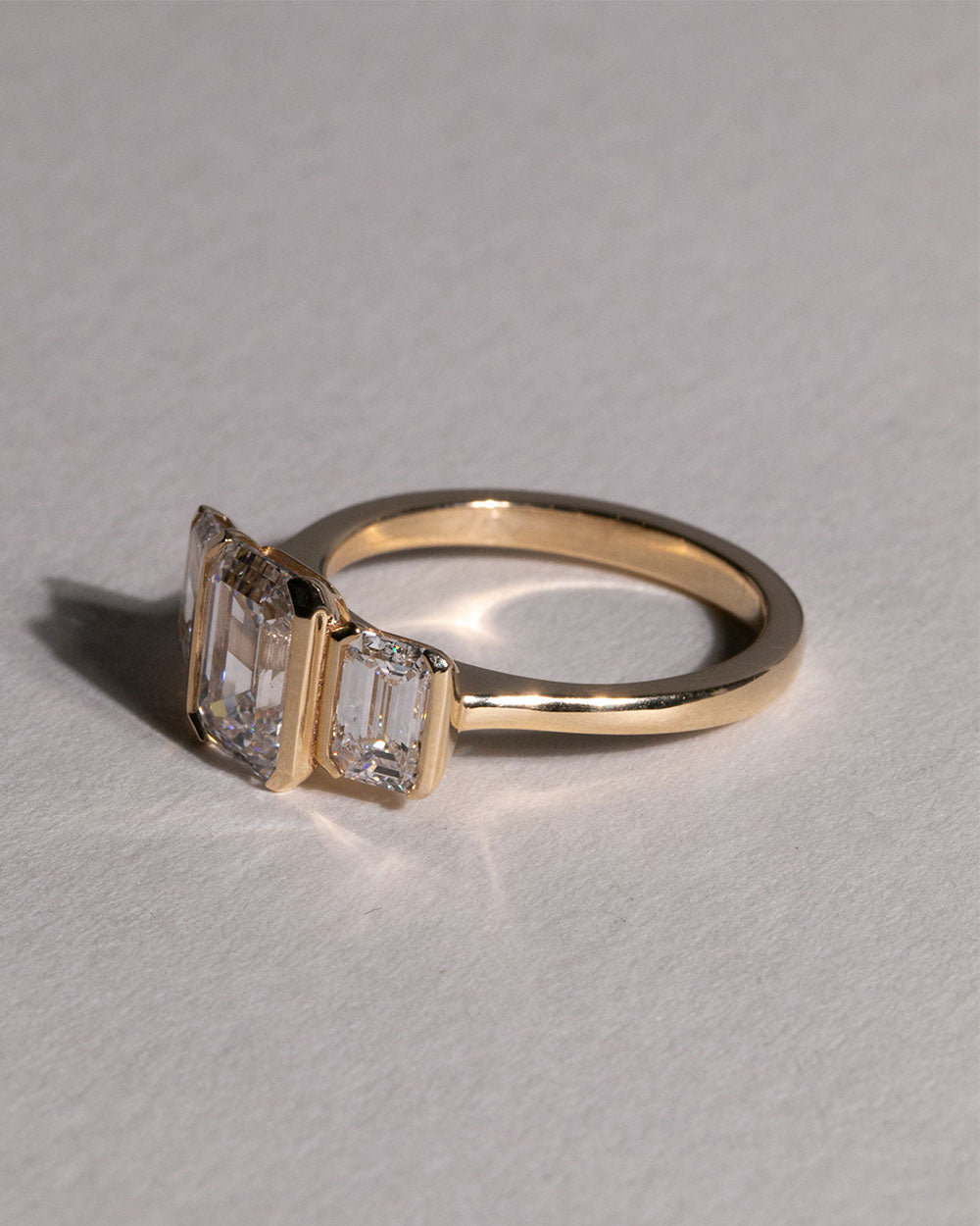 Front/side view of 9ct Gold 2.05ct Emerald Cut Lab Grown Diamond Trilogy Ring.
