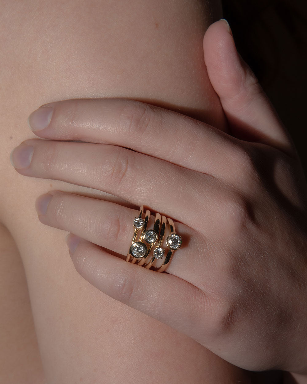 model wearing a stack of rings including 0.5ct Lab Grown Diamond Bezel Ring with 9 Ct solid gold band