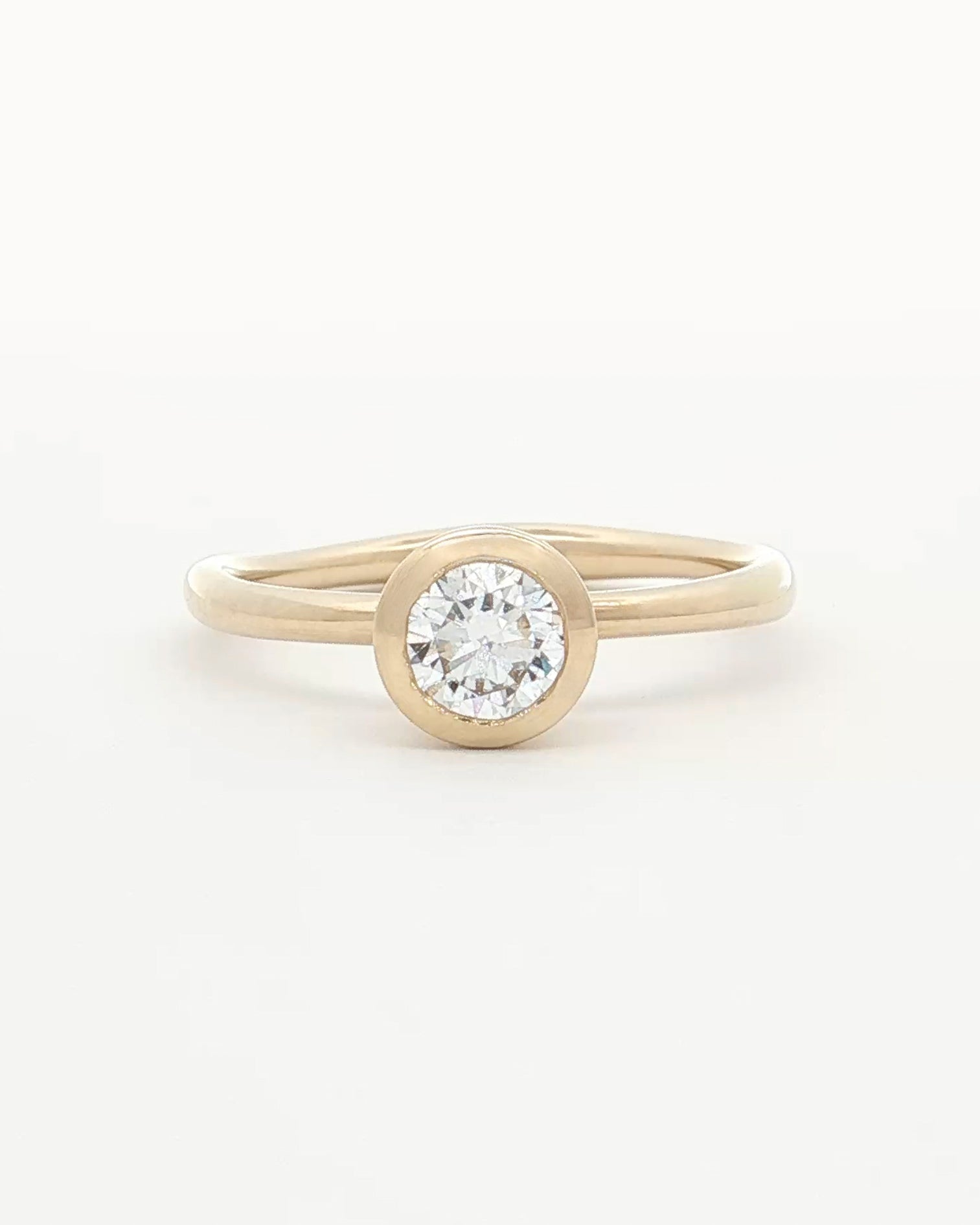 front view of 0.5ct Lab Grown Diamond Bezel Ring with 9 Ct solid gold band on white backdrop