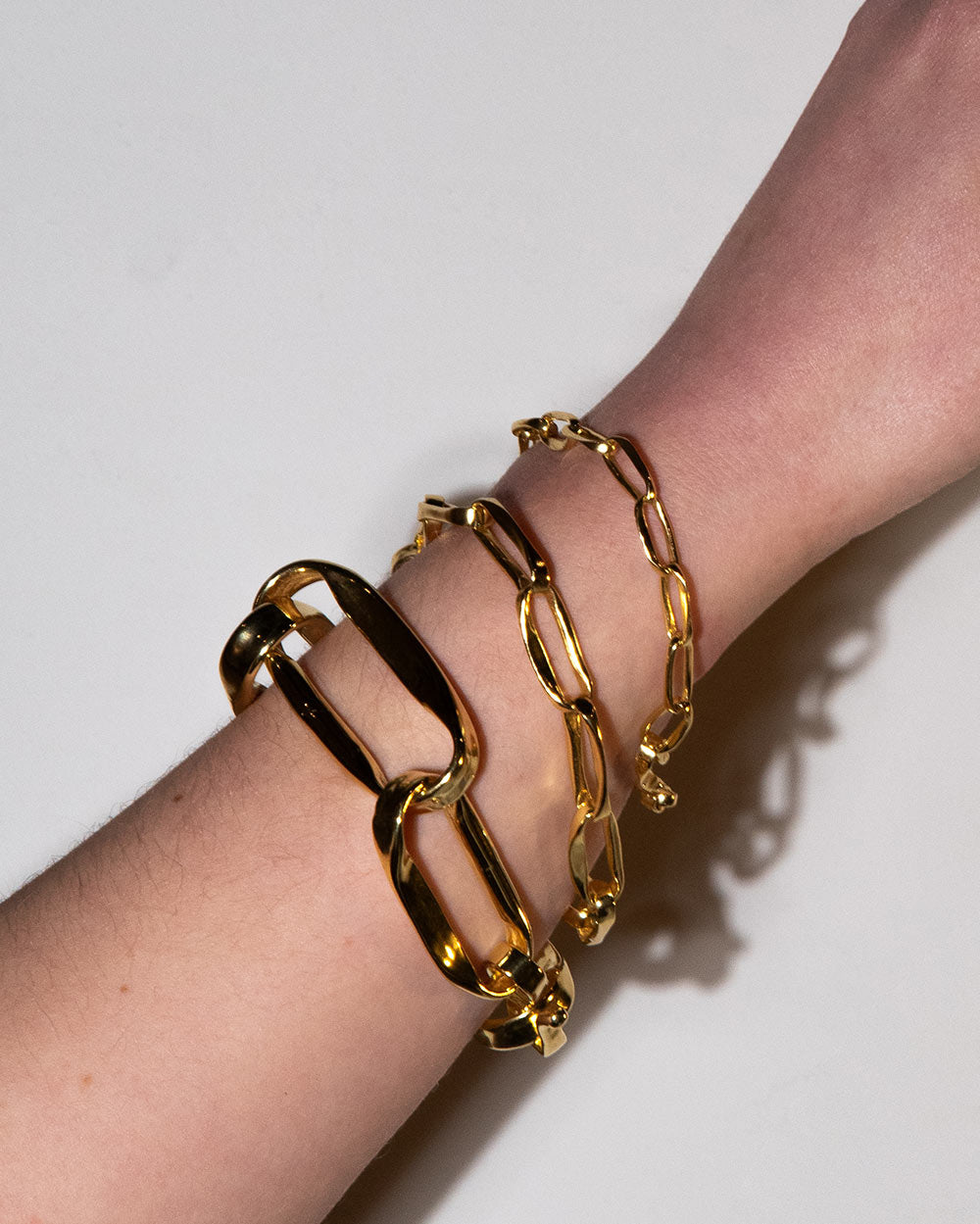 18 Ct gold plated brass MM STUDIO Link Heavy Chain Bracelet displayed on model with 2 other bracelets