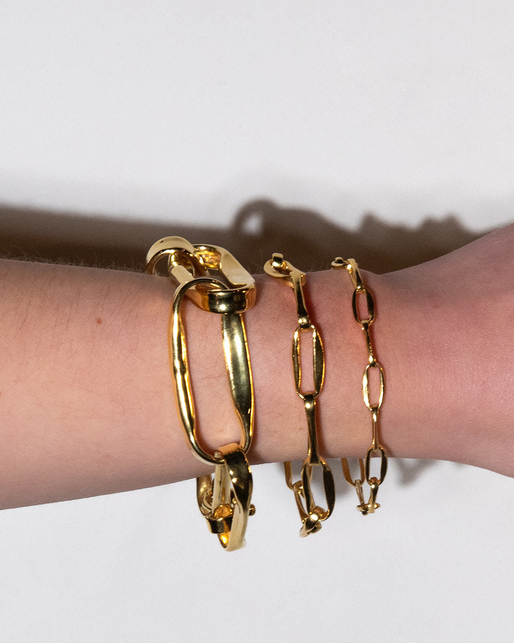 MM STUDIO Link Light Chain Bracelet displayed on wrist with 3 other bracelets