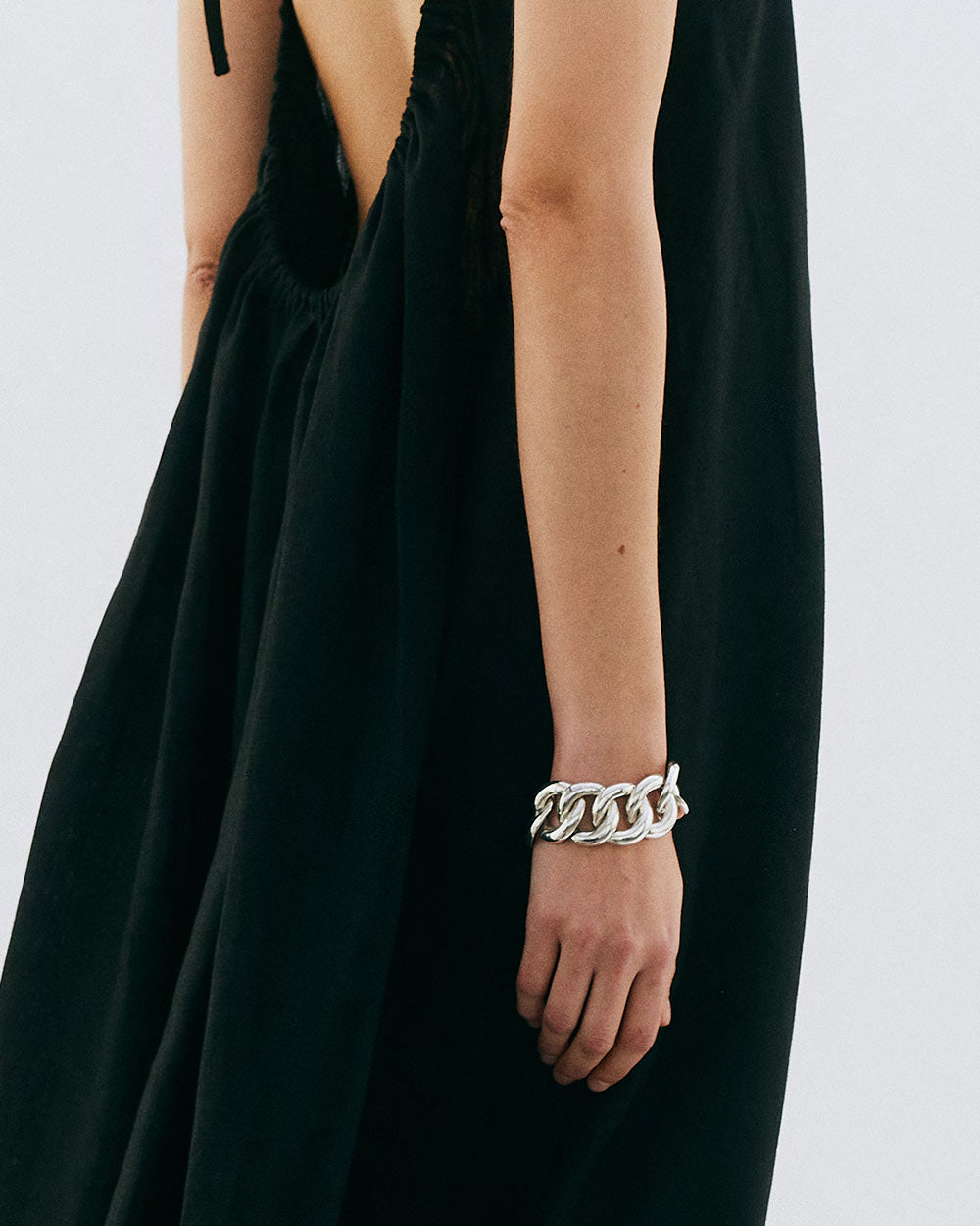 Back view of model wearing Sterling silver chunky organic chain bracelet.