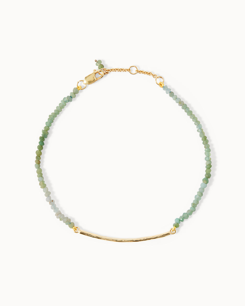 Milos bracelet by Maya Magal London, featuring light green chrysopase beads and a solid gold bar detail.