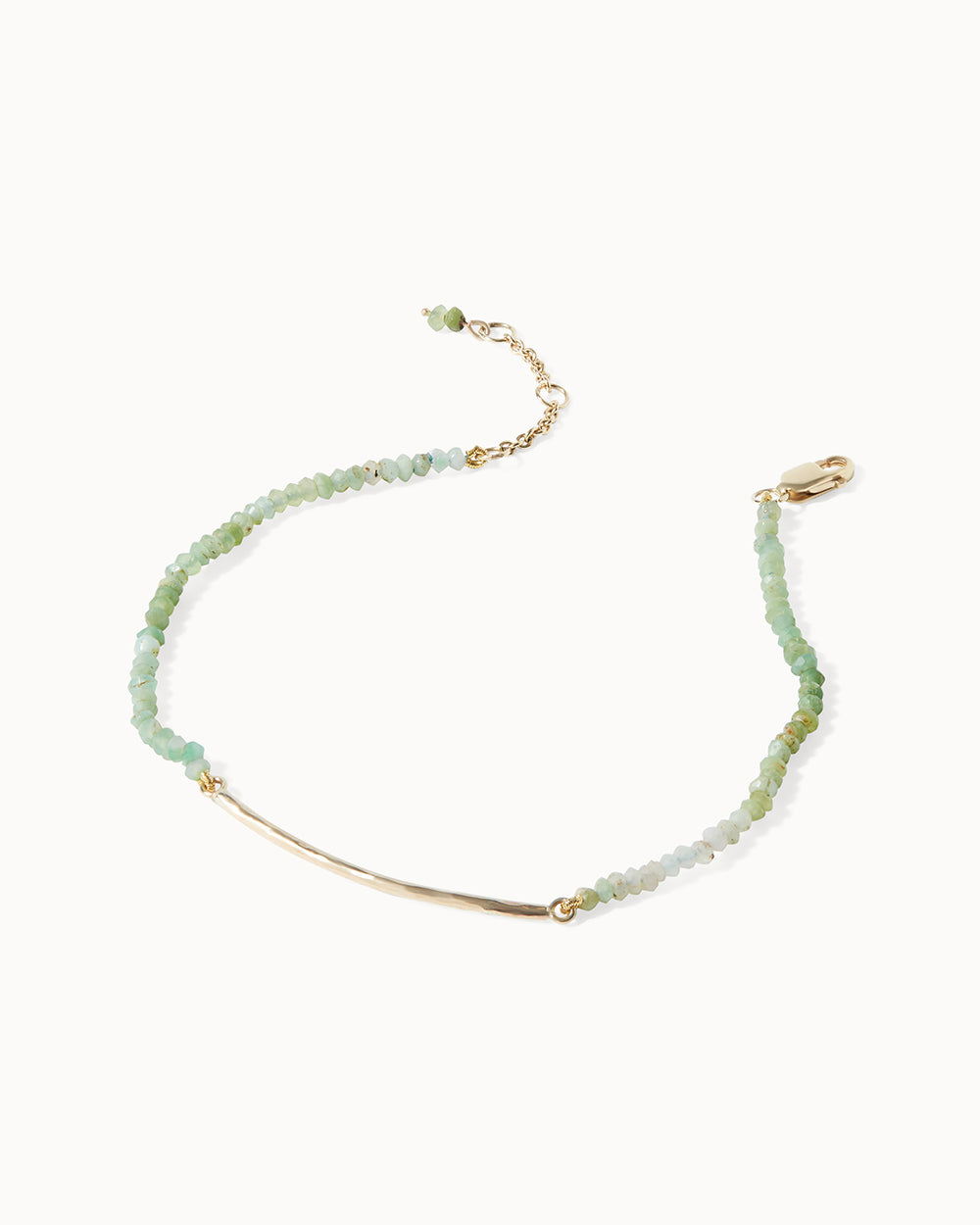 Delicate chrysopase beaded Milos bracelet with gold bar accent, handcrafted by Maya Magal London.