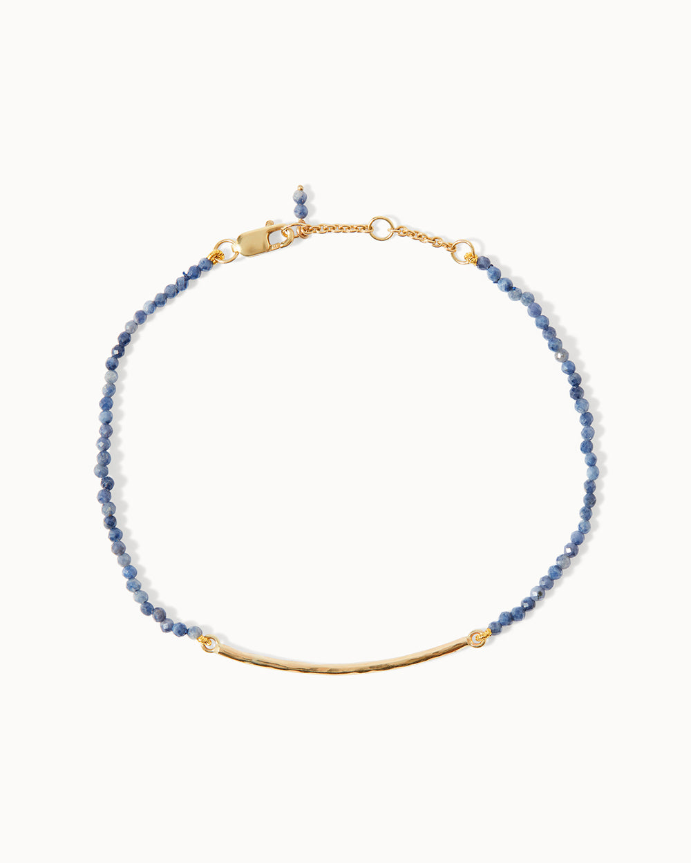 Milos bracelet with deep blue sapphire beads and solid gold bar, designed by Maya Magal London.