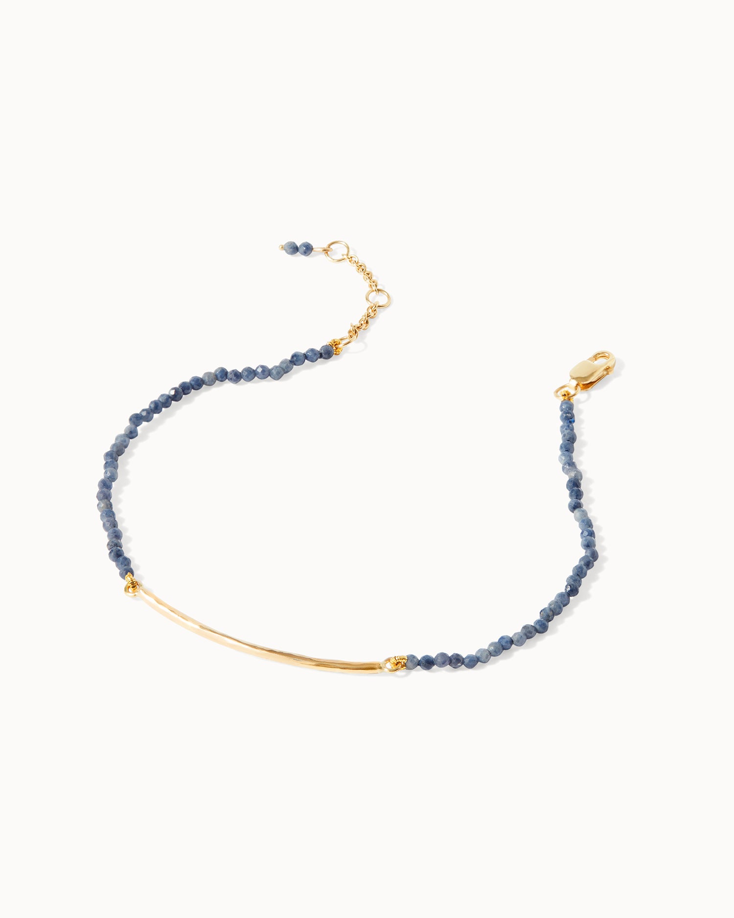 Handcrafted sapphire beaded Milos bracelet featuring a sleek gold bar, from Maya Magal London.