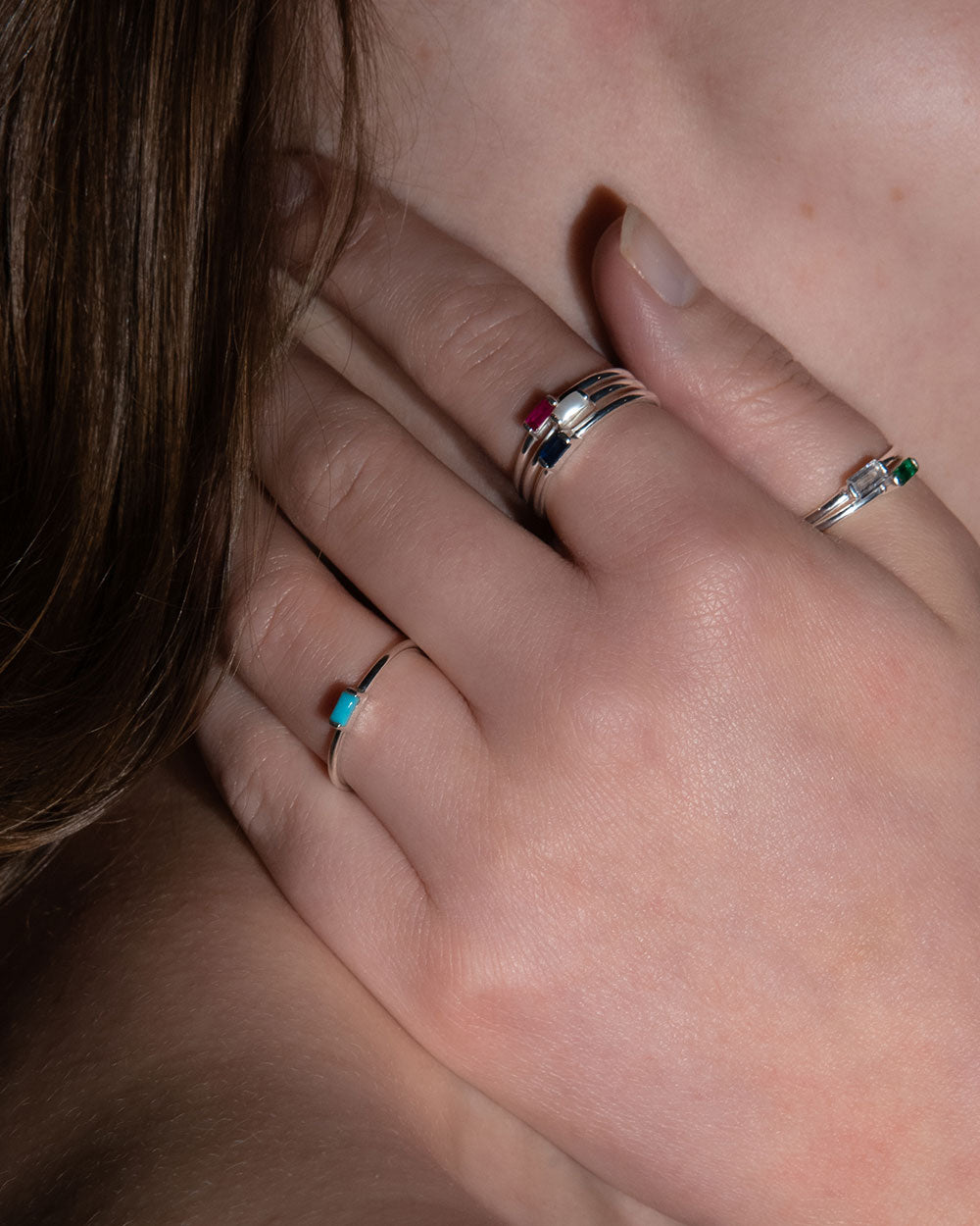 December Turquoise Birthstone Baguette Ring displayed with other birth stone rings on models hand
