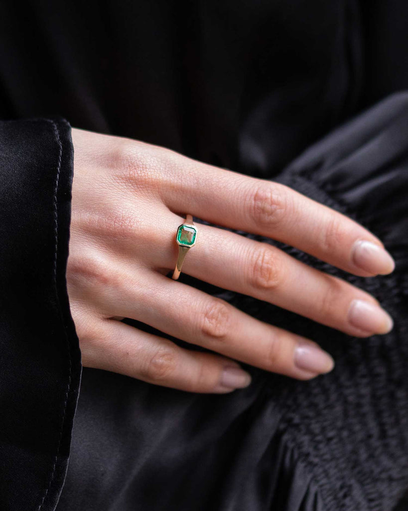 Emerald cut Emerald solitaire ring set in a recycled 9 ct solid yellow gold band handcrafted in London by Maya Magal