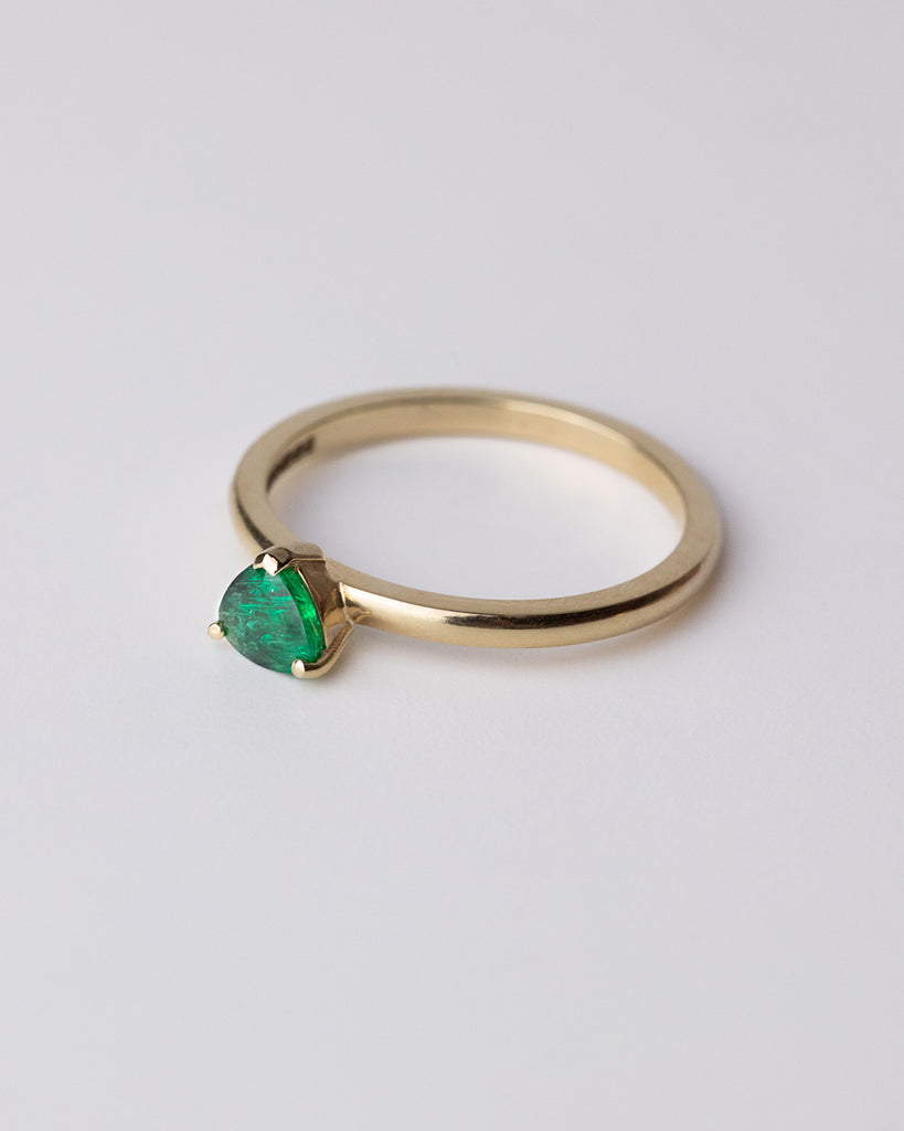 Pear cut emerald solitaire ring set in a recycled 9 ct solid yellow gold band handcrafted in London by Maya Magal