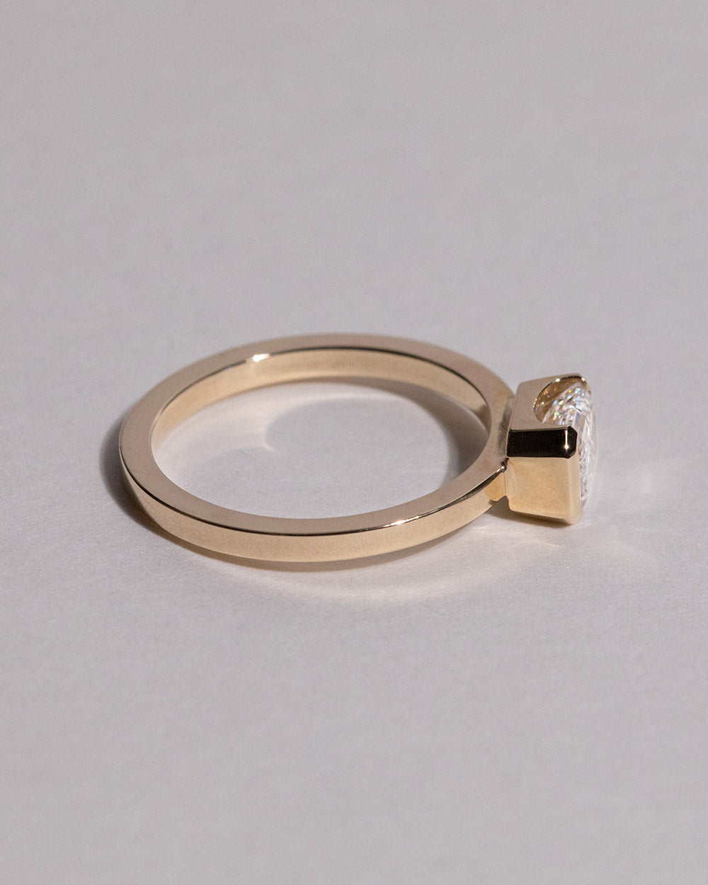 Side view of 9ct Gold Emerald Cut 1ct Lab Grown Diamond Ring on white background.