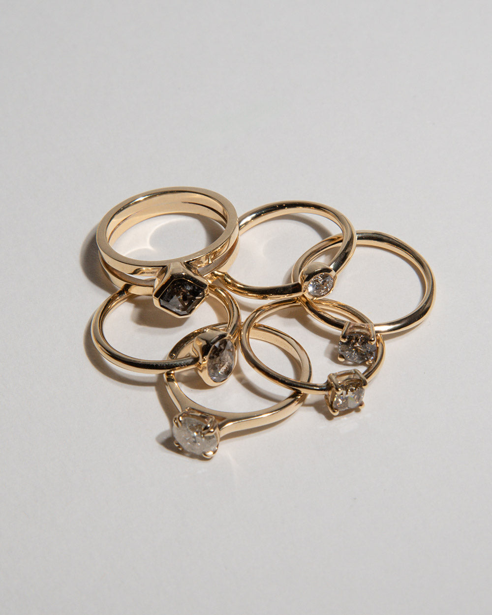 9 Ct solid gold Odette 1.28ct Grey Diamond Ring scattered with 4 other rings on white background