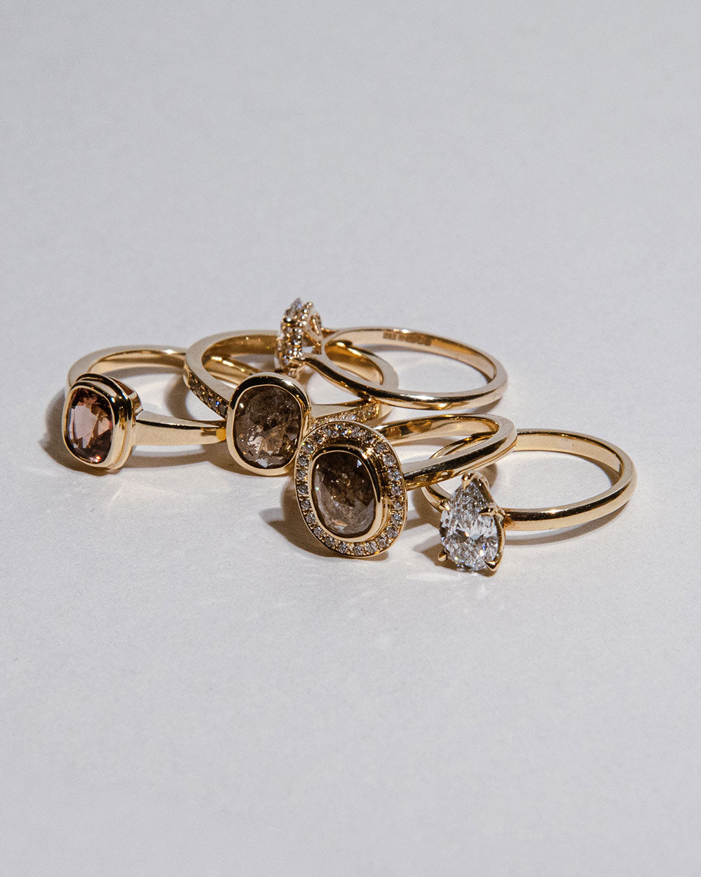 9 Ct solid gold Nieve 1.2ct Grey Diamond Ring displayed with 4 other rings on white backdrop