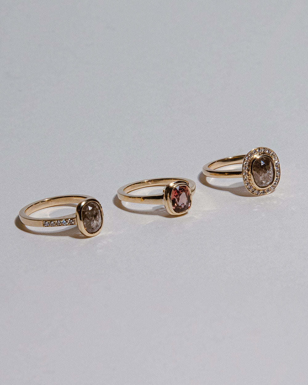 9 Ct solid gold Nieve 1.2ct Grey Diamond Ring displayed with 2 other rings on white backdrop