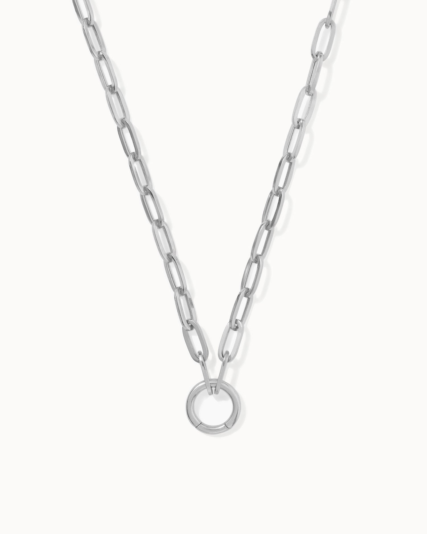 A sterling silver paper chain charm necklace with a statement clasp, displayed on a plain background.
