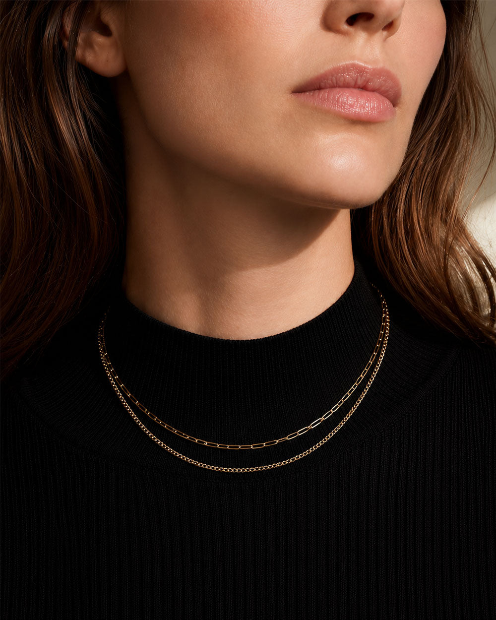 A classic paper chain necklace handcrafted in 9ct solid gold. Designed to be worn for the everyday, this effortlessly wearable piece is a modern jewellery essential. front view on model
