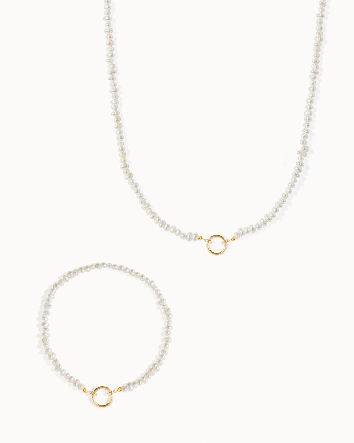 Milos pearl beaded charm necklace and bracelet set with solid gold details by Maya Magal London.