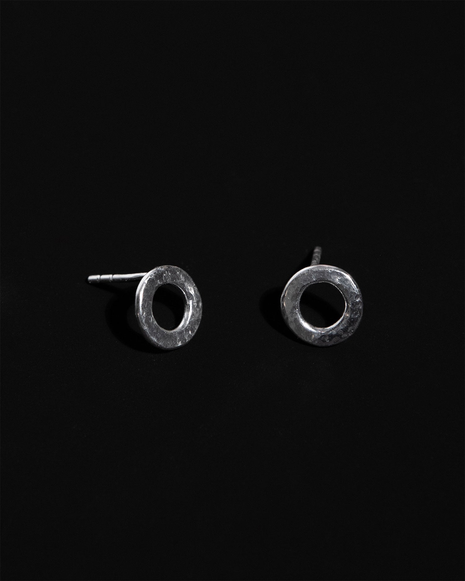 Statement sterling silver circular small stud earrings with hammered texture handcrafted in London by Maya Magal London