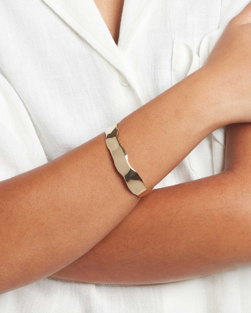 Model wears handcrafted recycled 9ct solid gold signature organic bangle bracelet