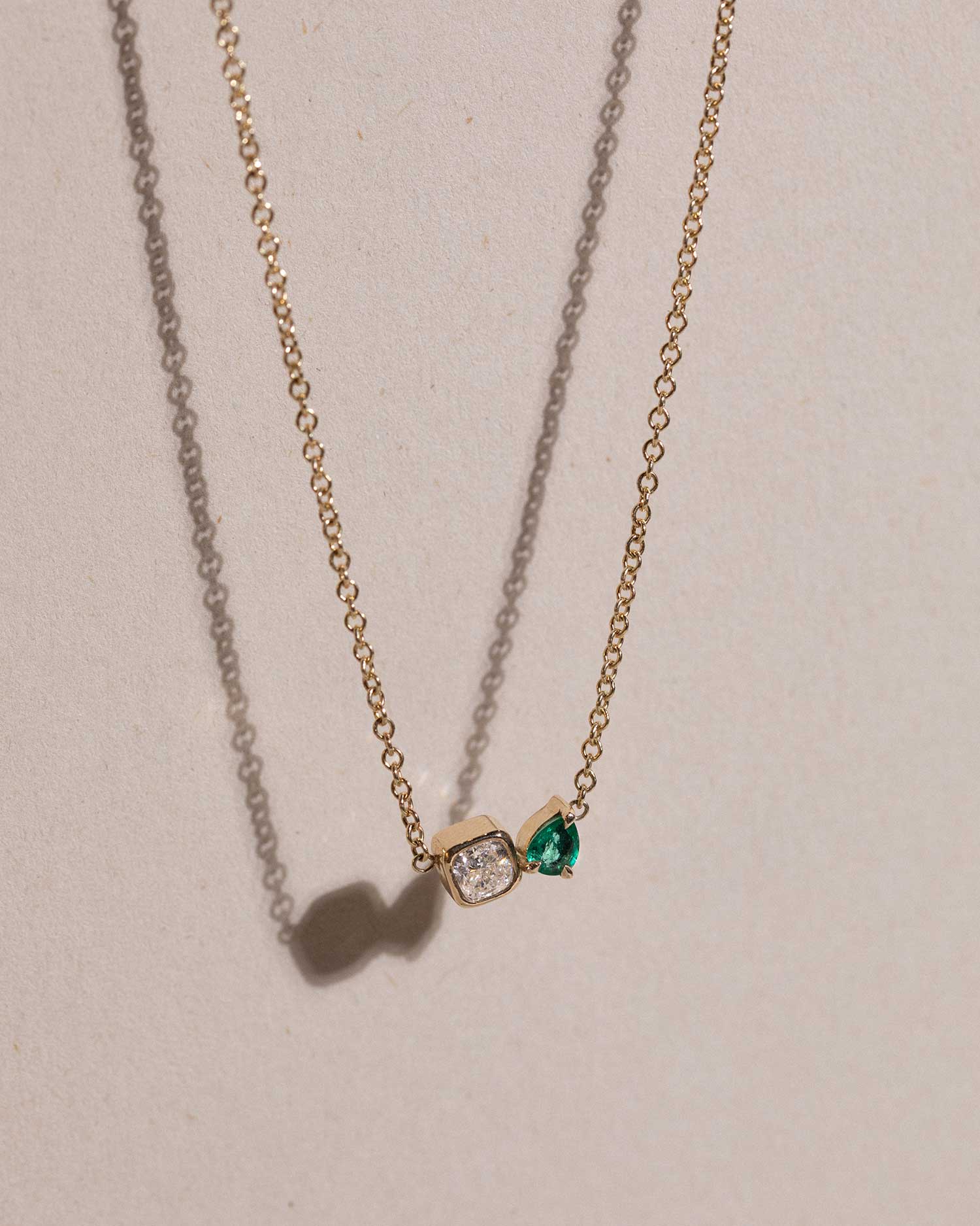 toi et moi necklace with 0.36ct lab grown diamond and pear cut emerald. Handcrafted in London by Maya Magal London