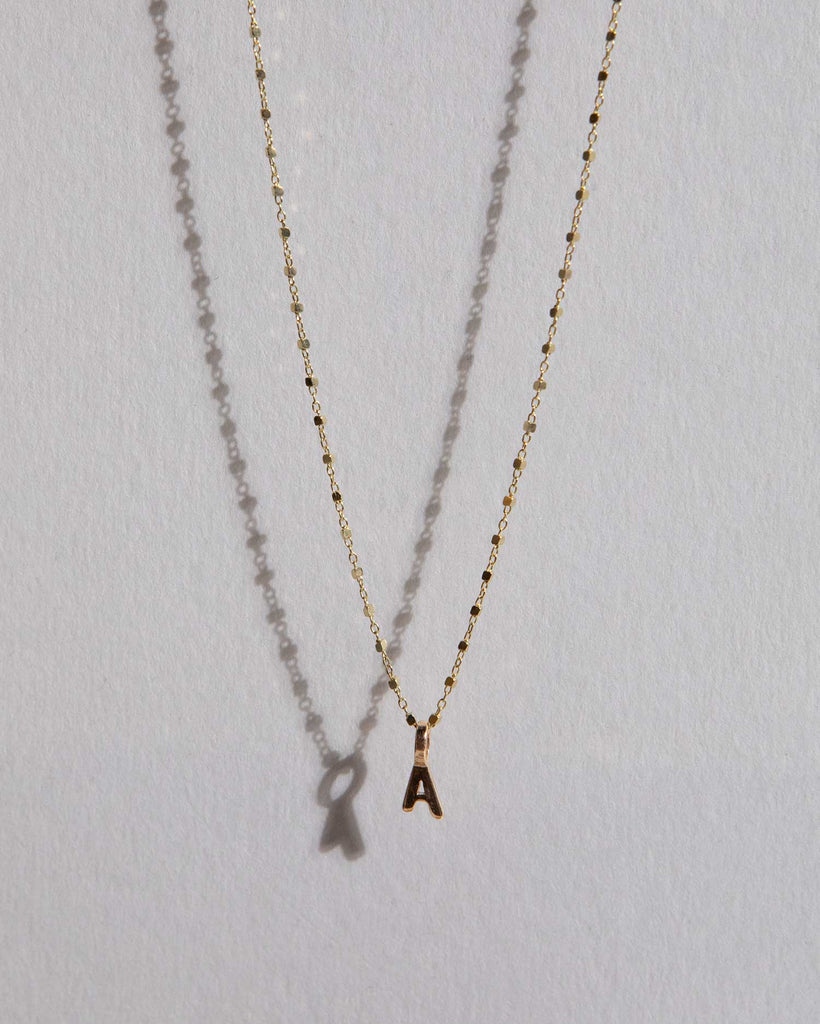 Recycled 9ct solid gold initial charm necklace handmade in London by Maya Magal London