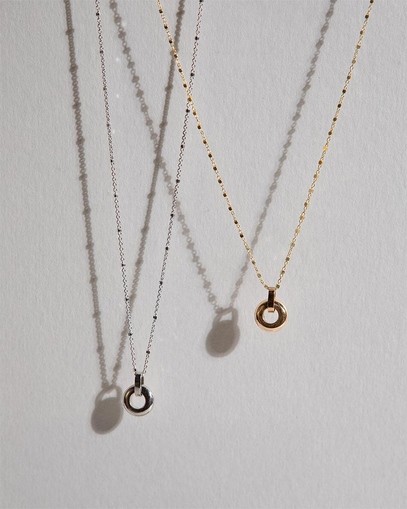 Recycled 925 sterling silver and 9ct solid gold chains with open circle charms handmade in London by Maya Magal London