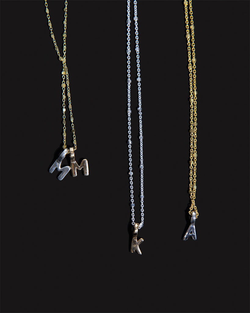 Recycled 925 sterling silver and 9ct solid gold chains with initial charms handmade in London by Maya Magal London