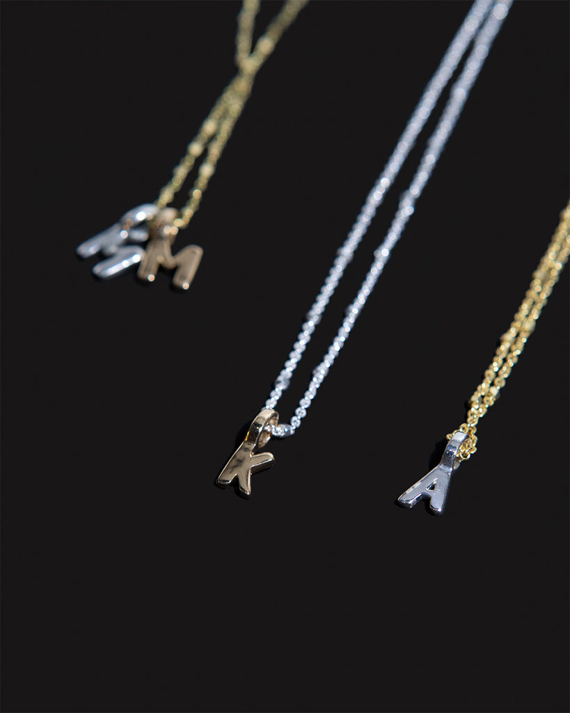 Recycled 925 sterling silver and 9ct solid gold chains with initial charms handmade in London by Maya Magal London