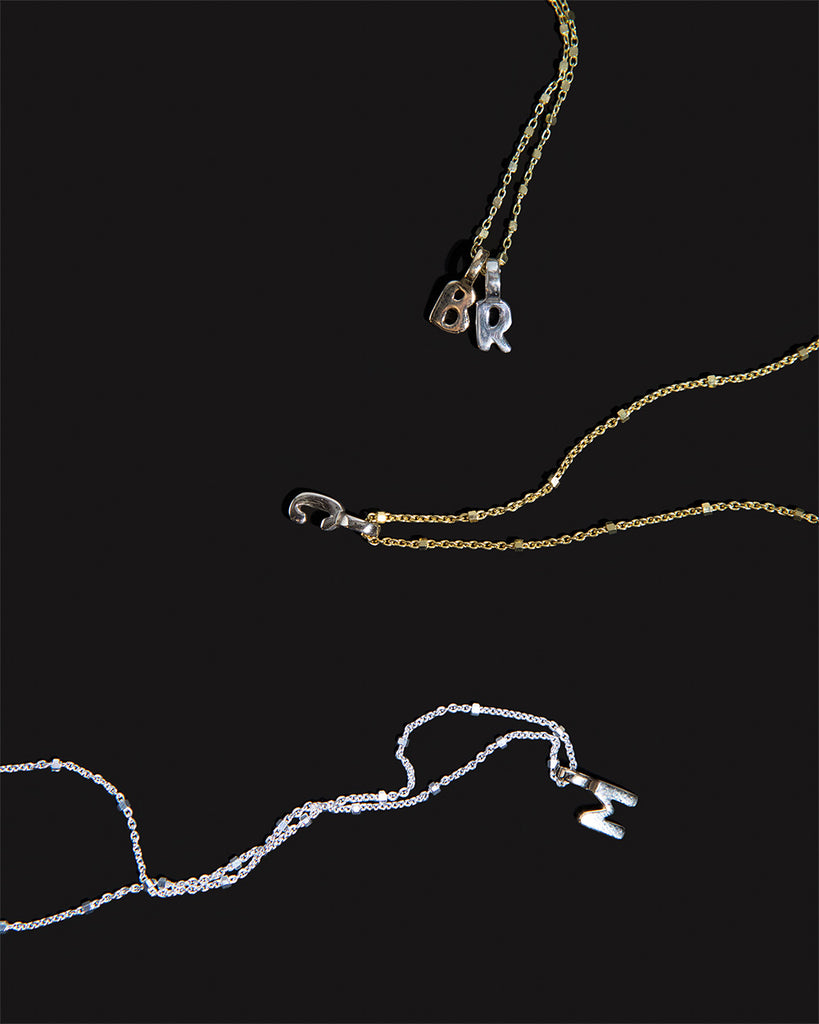 Recycled 925 sterling silver and 9ct solid gold chains with initial charms handmade in London by Maya Magal London