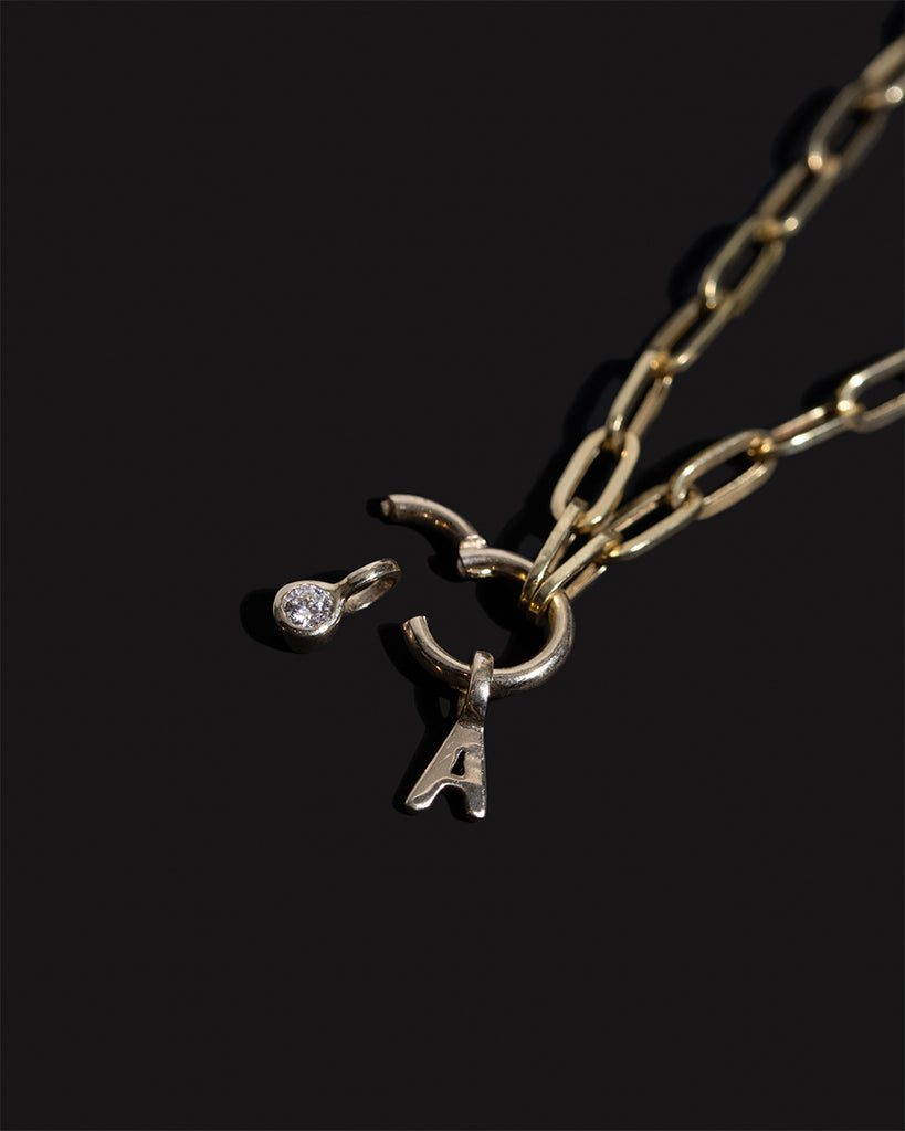 Recycled 9ct solid gold initial charm necklace with lab-grown diamond charm handmade in London by Maya Magal London