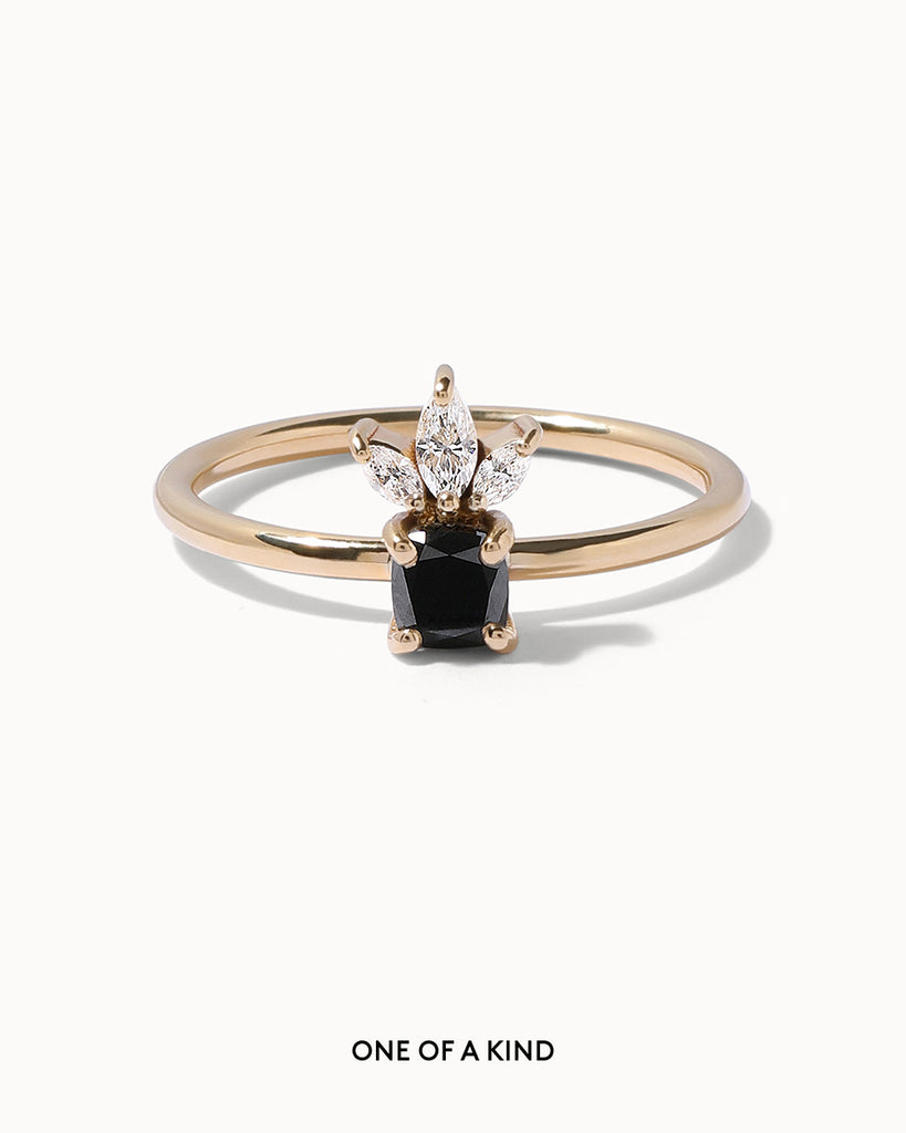 solid gold engagement ring featuring a jet black diamond and three sparkling marquise cut white diamonds handcrafted in London by Maya Magal London