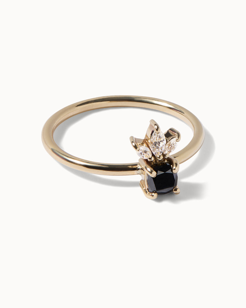 solid gold engagement ring featuring a jet black diamond and three sparkling marquise cut white diamonds handcrafted in London by Maya Magal London