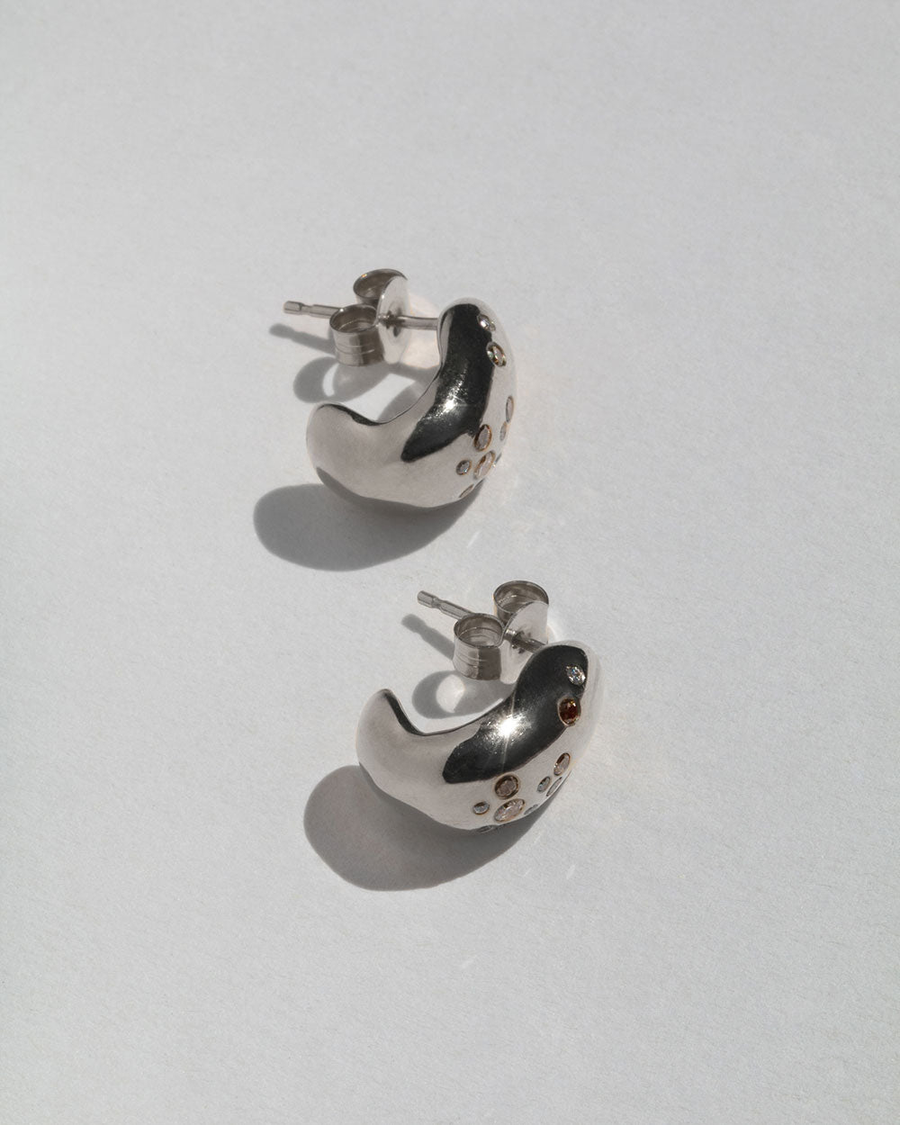  9ct solid gold  hoop earrings with flush set white and champagne diamonds. 