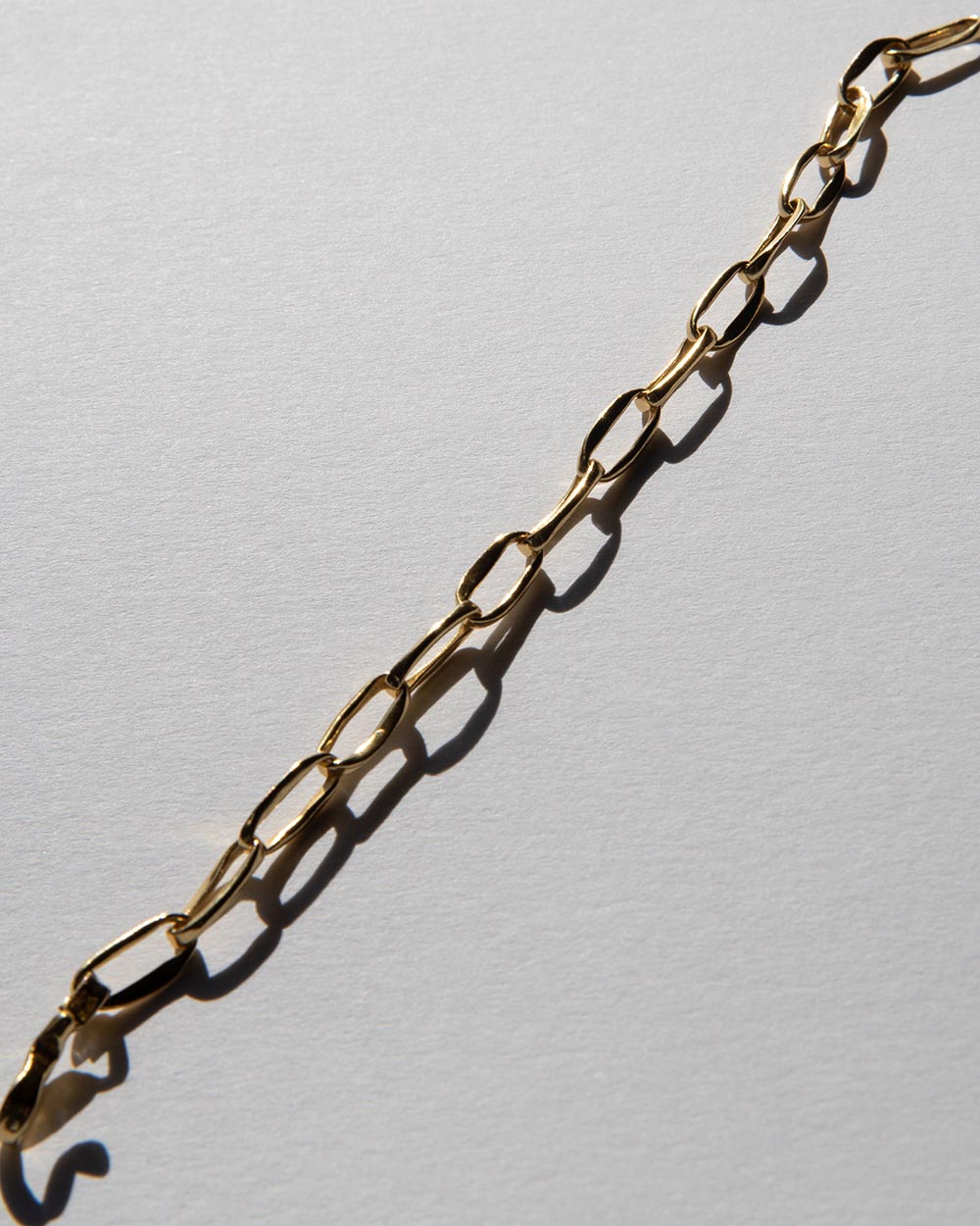 MM STUDIO Link Light Chain Bracelet laid across white background