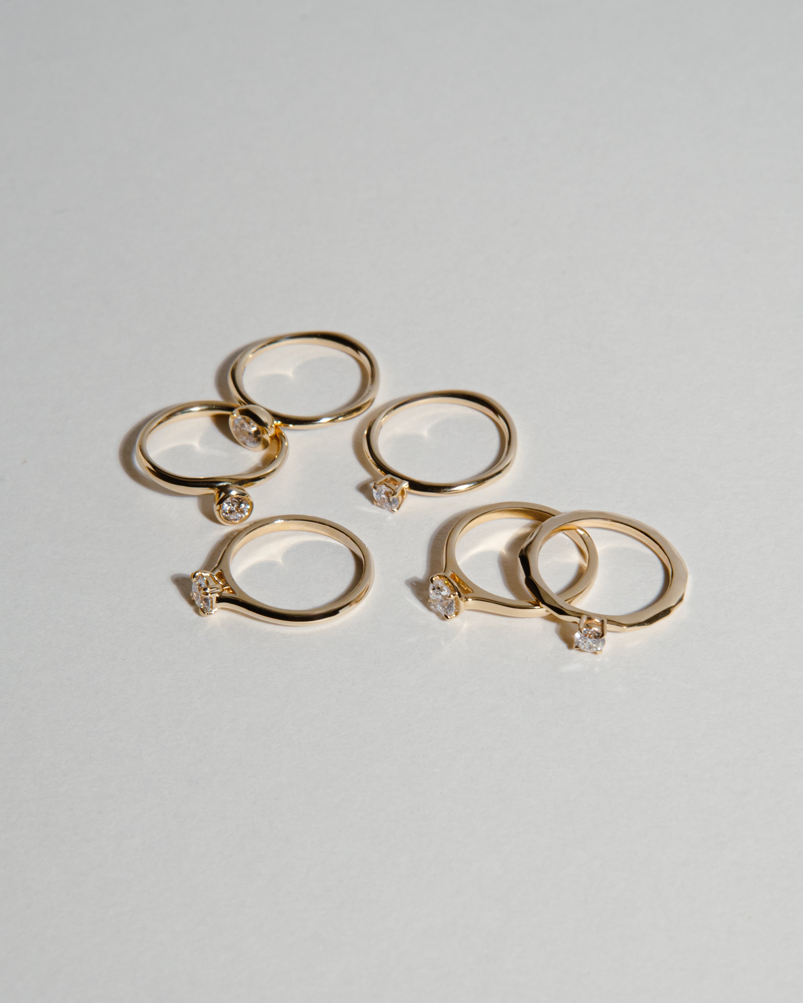 0.25ct Lab Grown Diamond Organic Ring  with 9 Ct solid gold band displayed scattered with other gold rings 