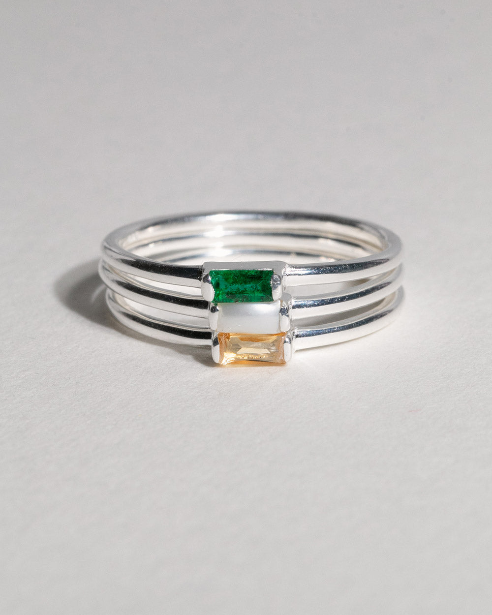 stack of 2 silver birthstone rings including May Emerald Birthstone Baguette Ring