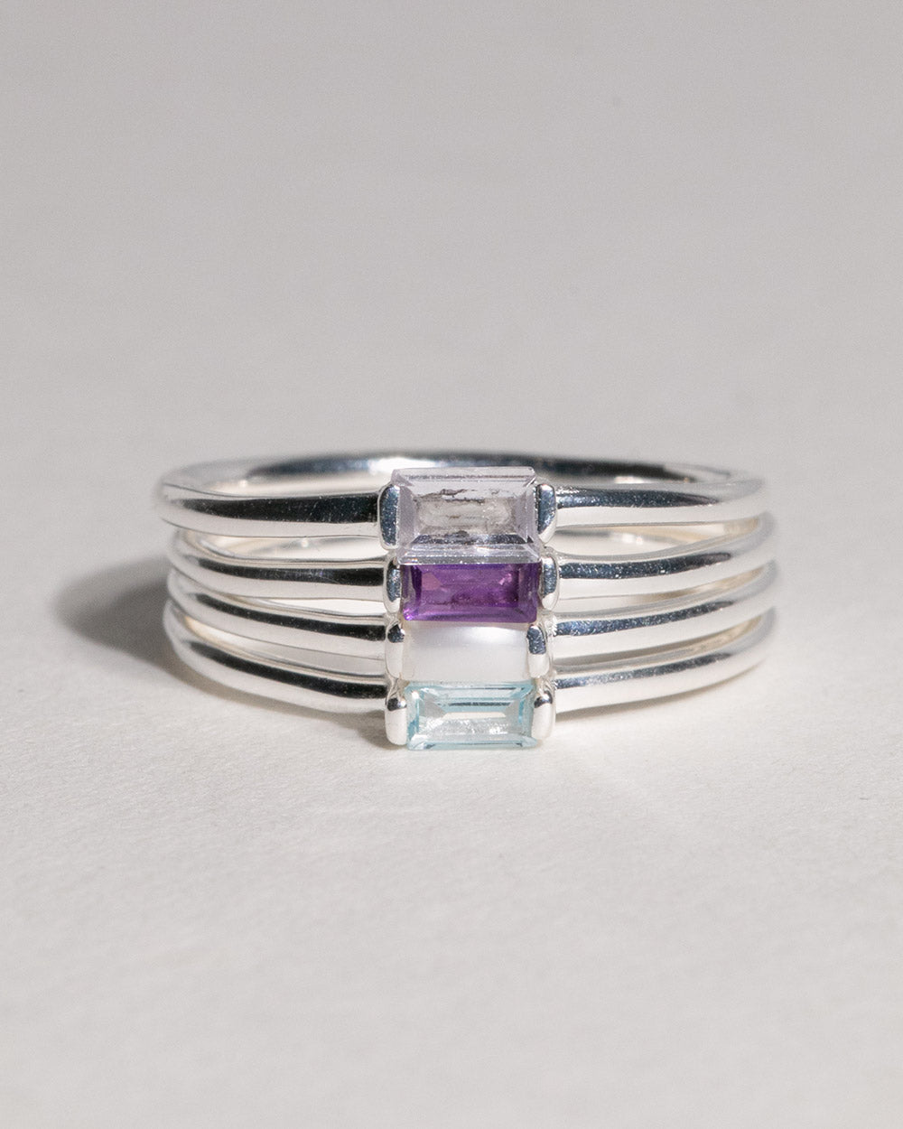 stack of sterling silver birthstone rings including March Aquamarine Birthstone Baguette Ring