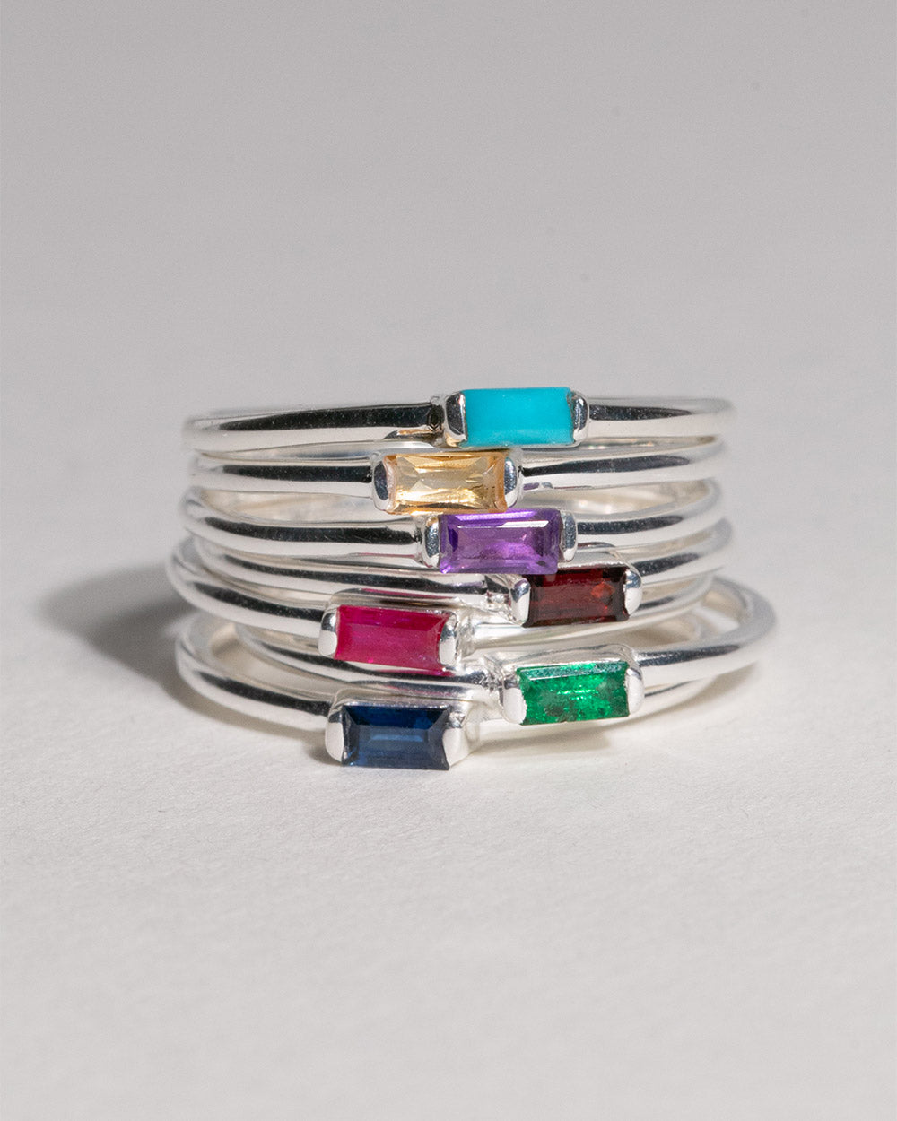 stack of birthstone rings including September Sapphire Birthstone Baguette Ring