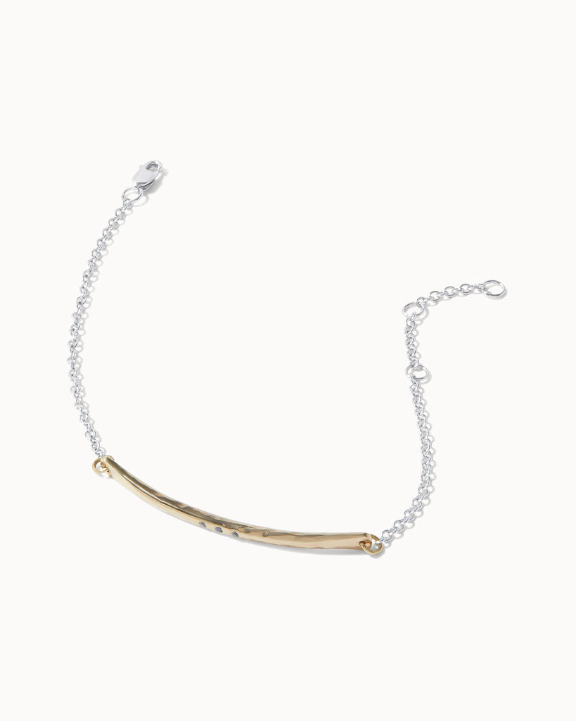 Recycled solid yellow and white gold chain bracelet featuring a hand carved bar with three black diamonds handcrafted in London by Maya Magal London