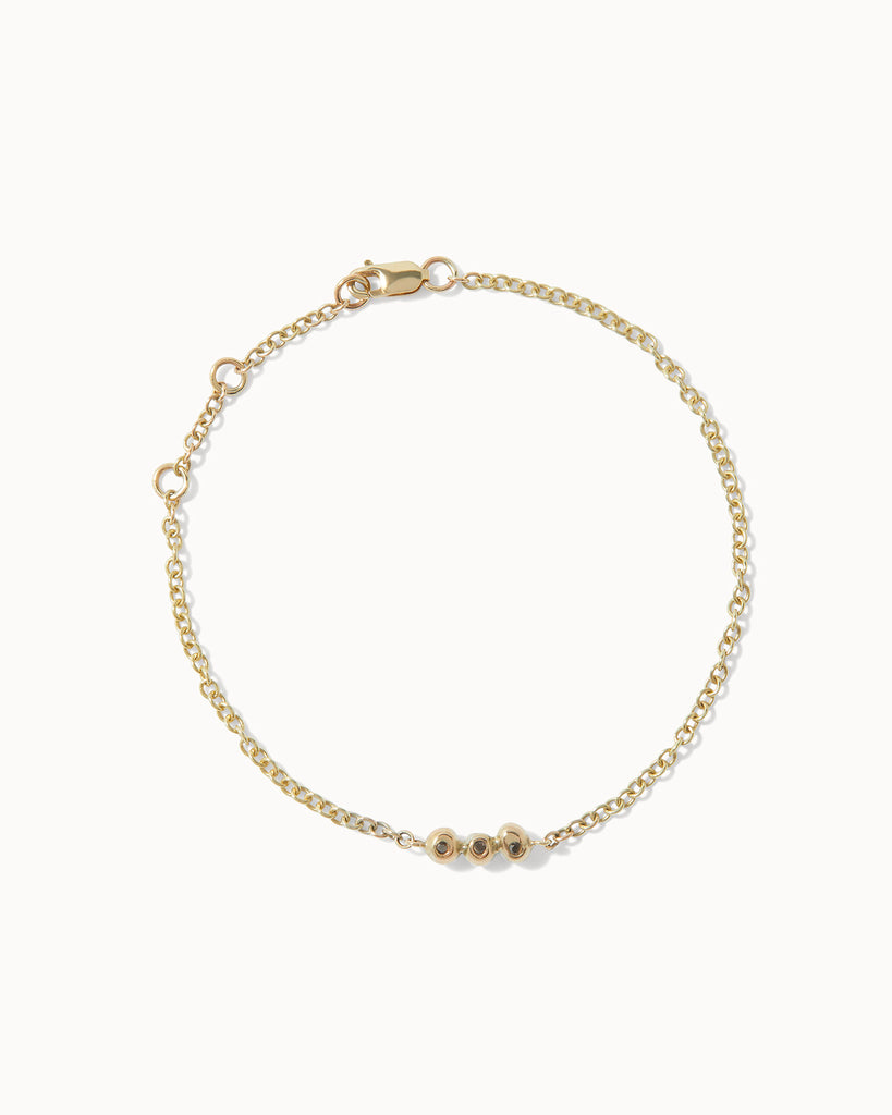 Recycled solid yellow gold chain bracelet featuring three black diamonds in bezel setting handcrafted in London by Maya Magal London