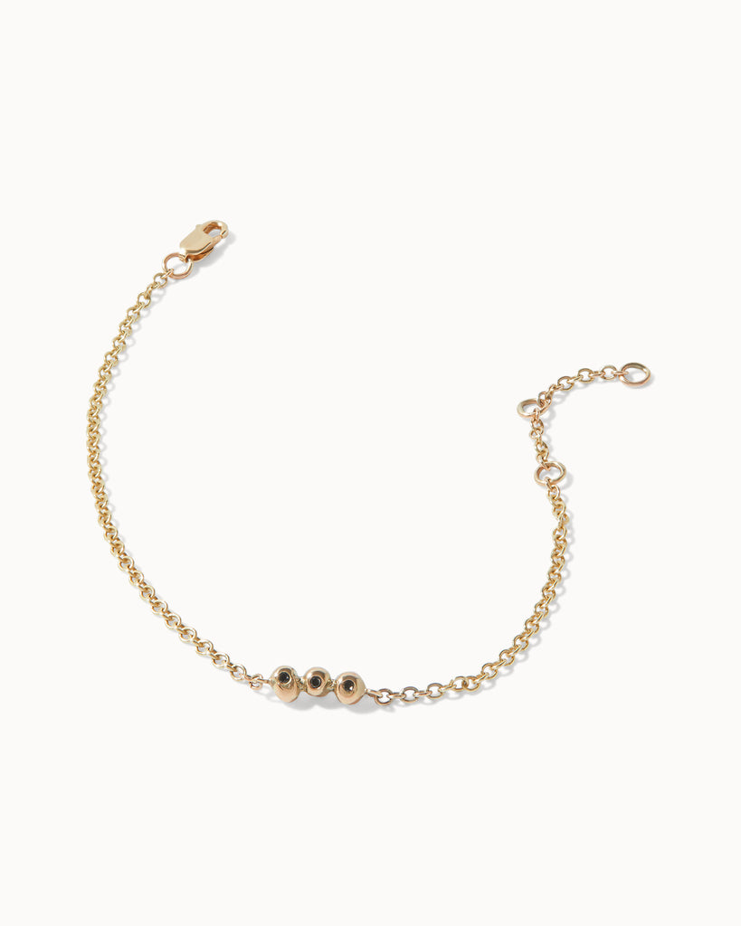Recycled solid yellow gold chain bracelet featuring three black diamonds in bezel setting handcrafted in London by Maya Magal London