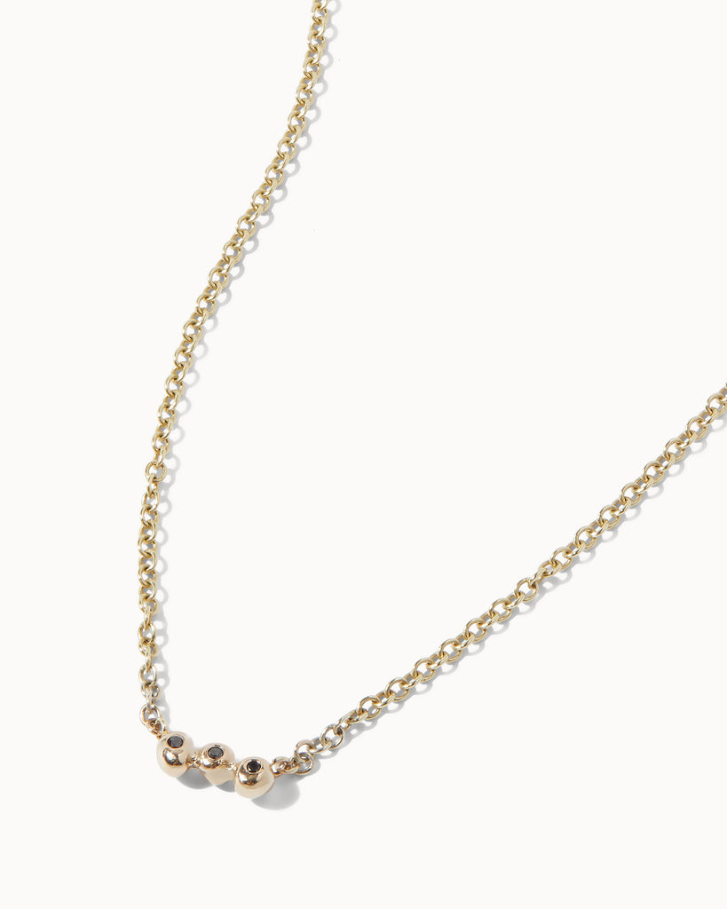 Recycled solid yellow gold chain necklace featuring three black diamonds in bezel setting handcrafted in London by Maya Magal London