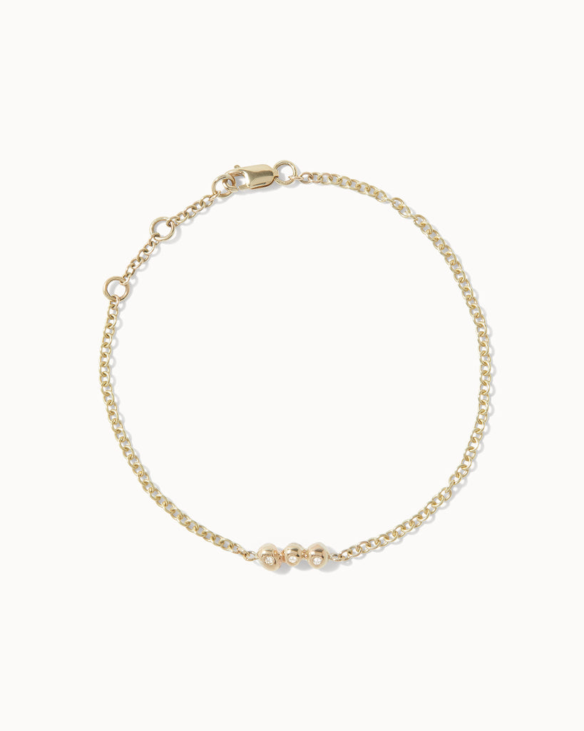 Recycled yellow gold chain bracelet featuring three white diamonds in bezel setting handcrafted in London by Maya Magal London
